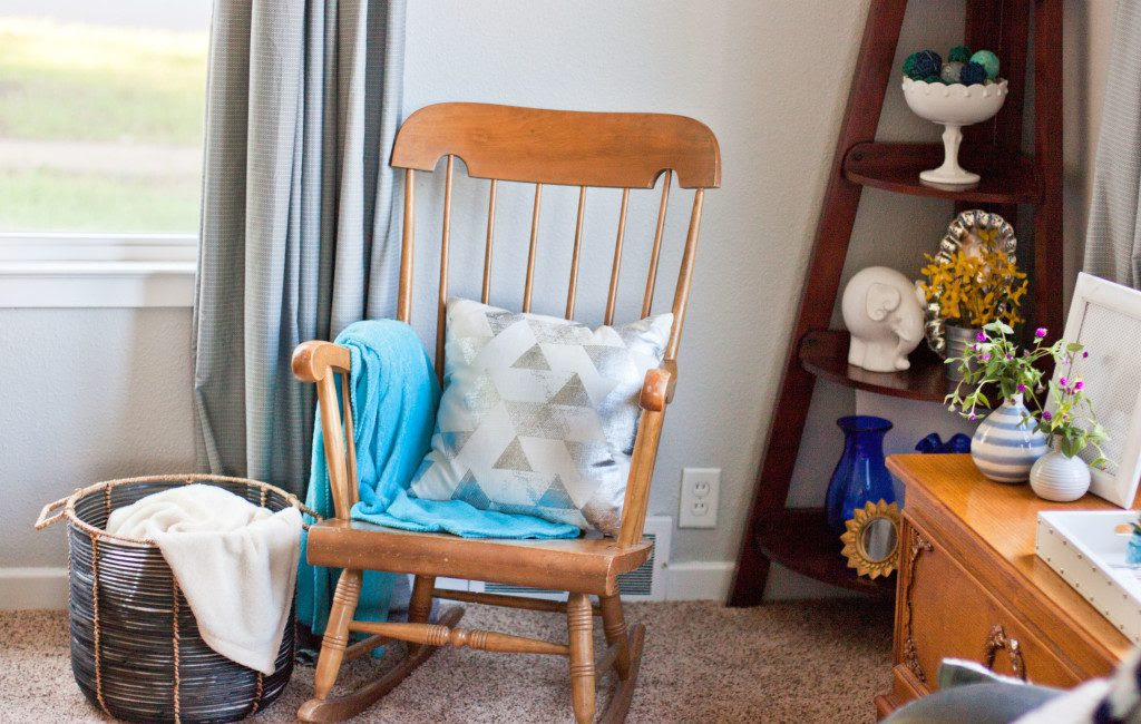 This living room looks so pretty! Love all of those blue pillows and that picture ledge/gallery wall.