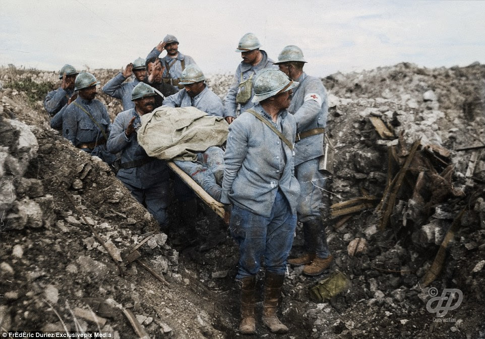French soldiers remove the body of fallen soldier on a stretcher from conquered ground at Cote 304 - which was the location of the Battle of Cote 304 during the Battle of Verdun - on August 25, 1917