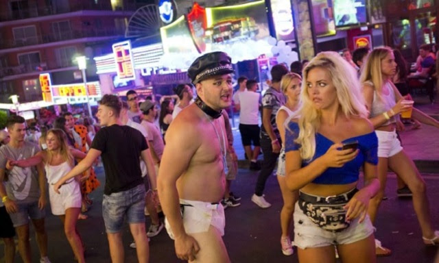 TO GO WITH AFP STORY BY ANNA CUENCA A British tourist shouts at a girl in Punta Ballena street, in the Magalluf zone, in Calvia on Mallorca Island late on August 1, 2014. The resort made headlines around the world last month after a video showing a young woman, wearing red shorts and a white tank top, performing oral sex on several men on the dance floor of a nightclub went viral on the Internet. AFP PHOTO/ JAIME REINA (Photo credit should read JAIME REINA/AFP/Getty Images)