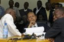 Former Haitian Dictator Duvalier listens as charges against him are announced during an appeals court hearing in Port-au-Prince