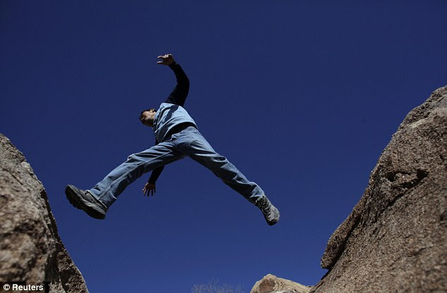 Jump: The Hernandez' son Omar jumps from rock to rock close to his family's home near San Jose de Las Piedras in Coahuila, Mexico