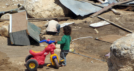 A boy near demolished structures in the Palestinian community of al-Khdeirat this morning. Photo: 'Amer 'Aruri, B'Tselem.