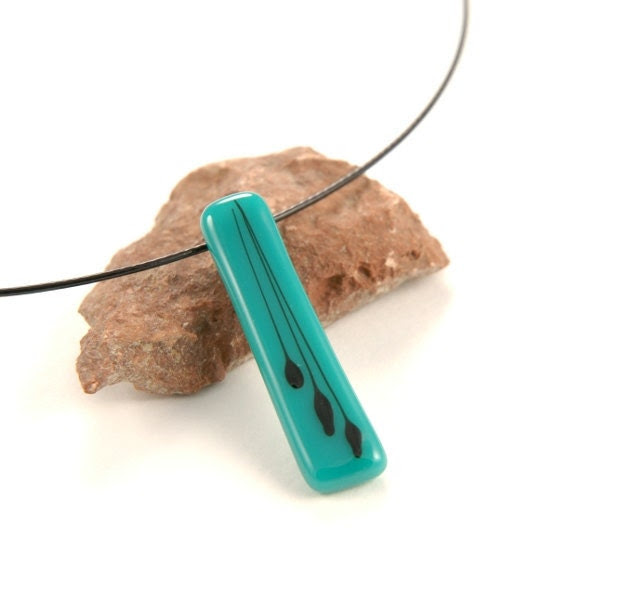 Teal fused glass necklace with black clematis seed floral pattern - PannaKotta