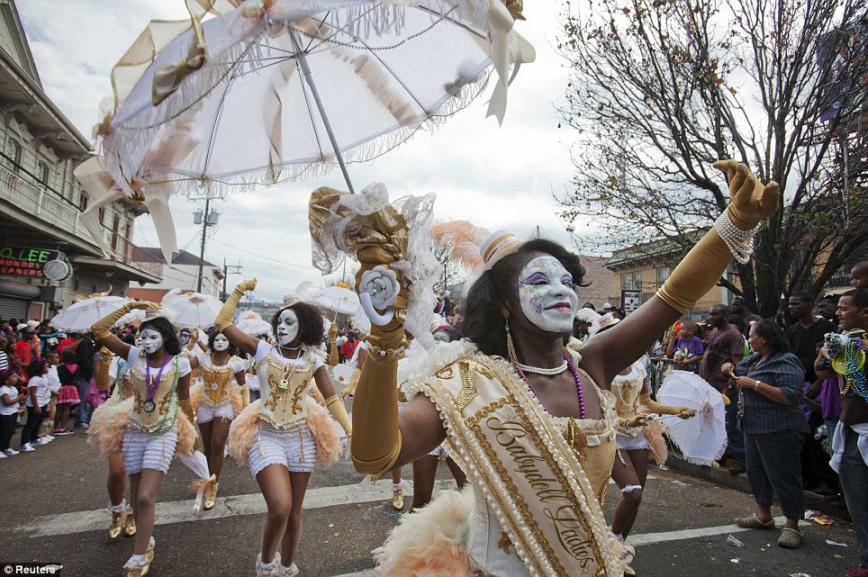 Dancing in the street: Dancers wearing gold babydoll outfits march the route of the Zulu parade