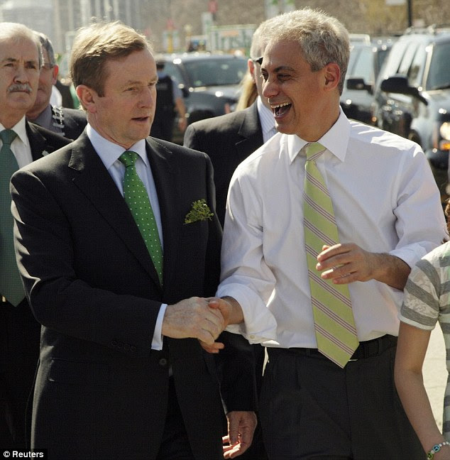 Holding hands: Irish Prime Minister Enda Kenny (left) walked Chicago's parade today with Mayor Rahm Emanuel