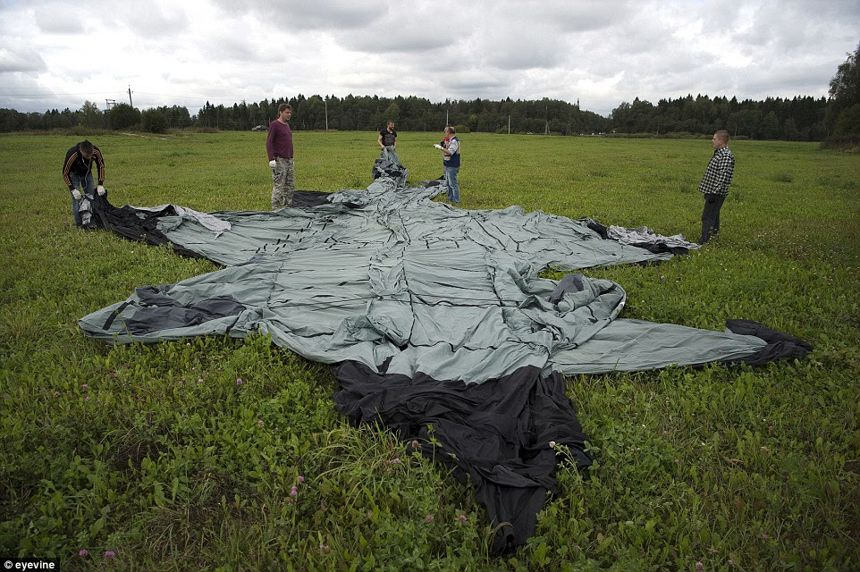 Employees prepare to inflate a copy of a Mig-31 in a field outside Sergeev Posad, 50 miles to the north of Moscow, where their factory is located.