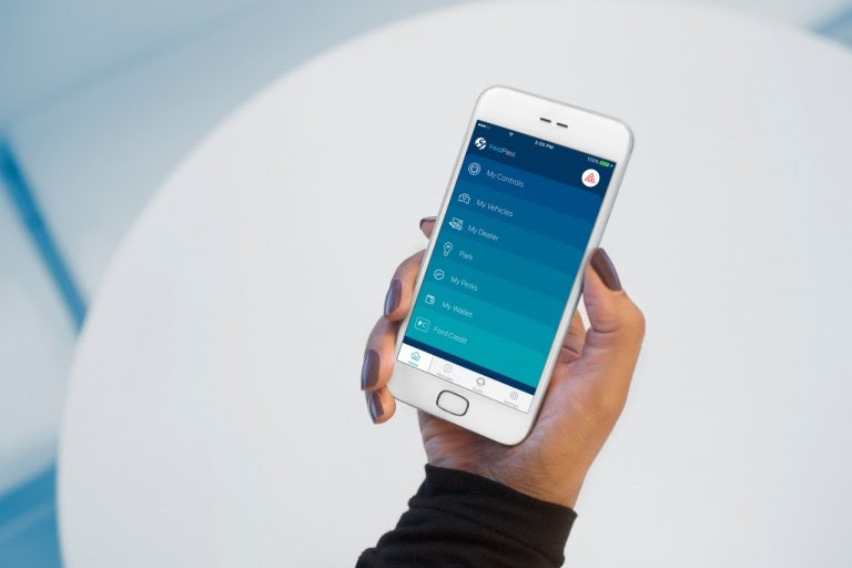 Woman's hand holding Samsung phone showing Ford's mobile application