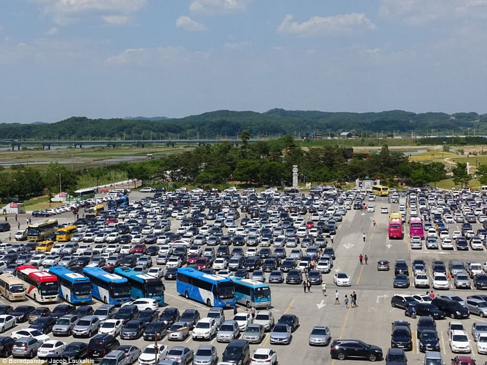 A car park in South Korea is packed full of cars and tour buses