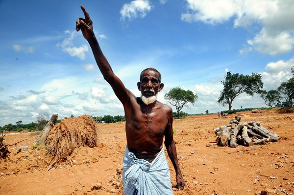 A man who lives on the land shouts at the governments decision to flatten the land destroying trees for a housing project. Image by Sanaul Haque. Copyright Demotix (5/8/2013) 