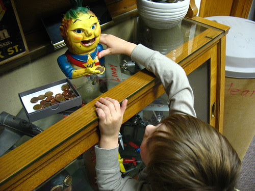 Ezra trying out a coin bank