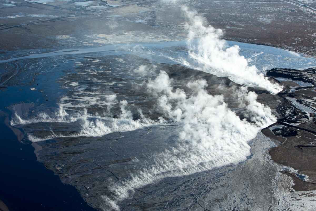 Hot waste filling tailing pond. Suncor mining site, Alberta, Canada.
