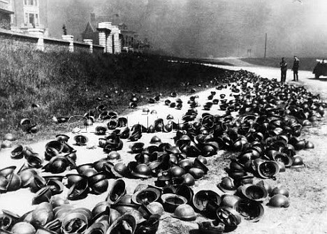 Escape: German soldiers examine helmets left on the beach at Dunkirk by British and French soldiers