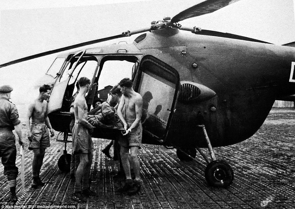 A wounded soldier is unloaded by his comrades from the only Sycamore helicopter which had been deployed to Kenya. Many of the service personell were National Service, some of whom had seen active service in Korea. Among the regulars were veterans of the Second World, the Palestine Emergency, Malaya and Korea