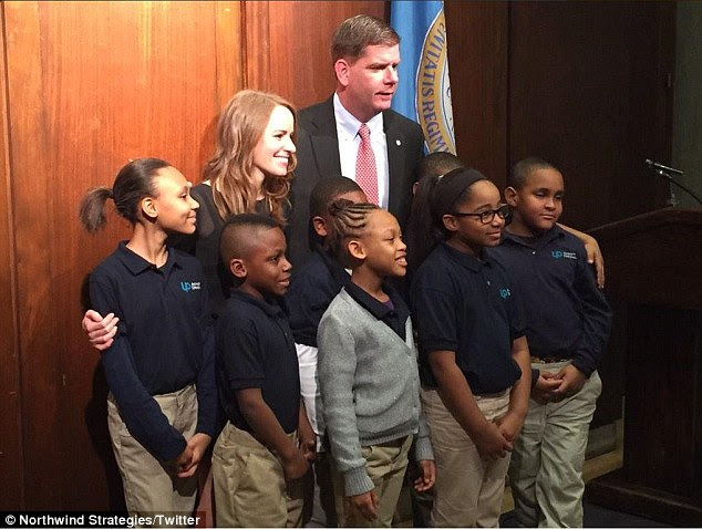 Celebration: Nikki Bollerman poses with some of her students and Boston Mayor Marty Walsh after she won a $150,000 prize from Capital One and then donated it back to the charter school where she works