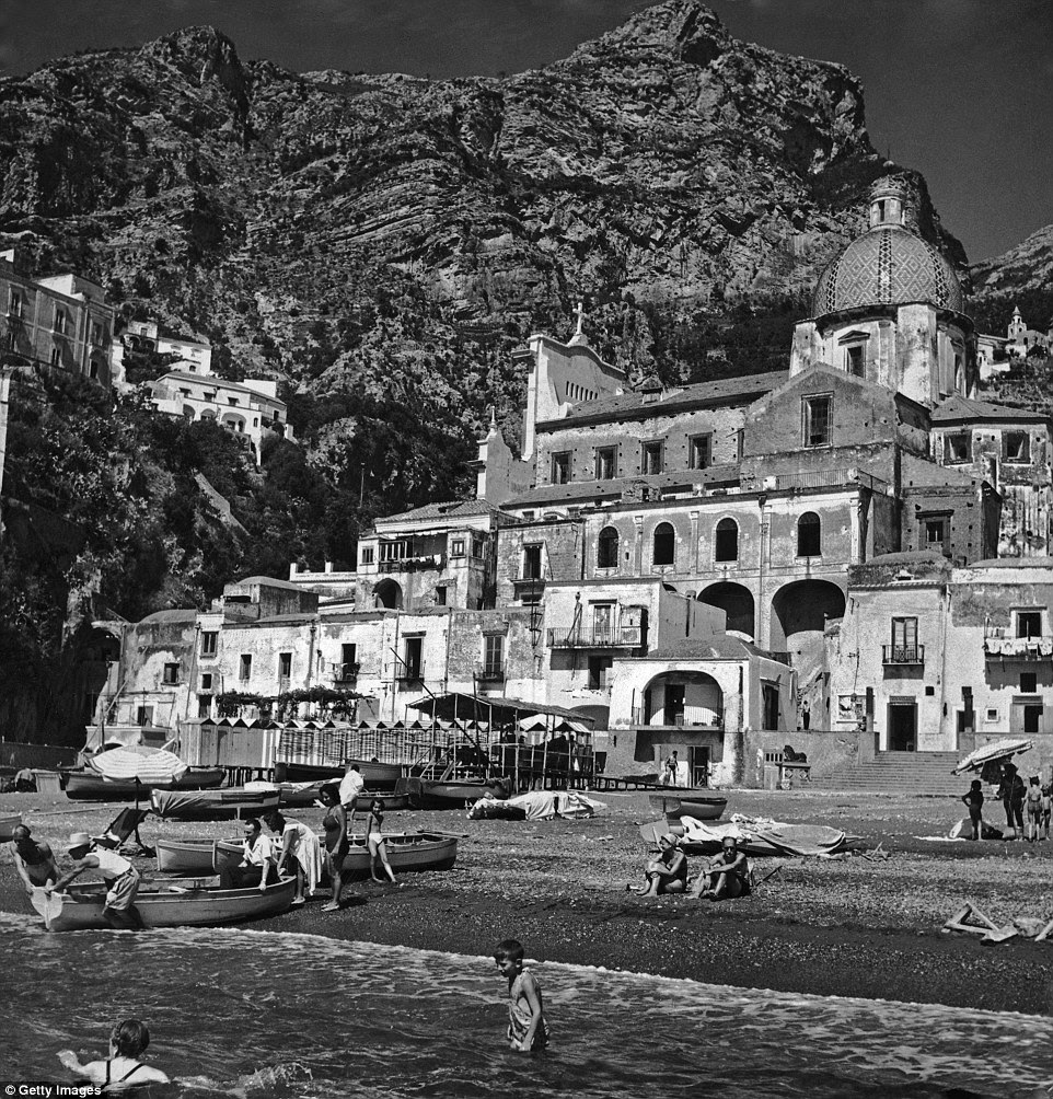 Vacation hot spot: Holidaymakers enjoy the sunshine and a swim on the beach at Positano, Italy, circa 1949