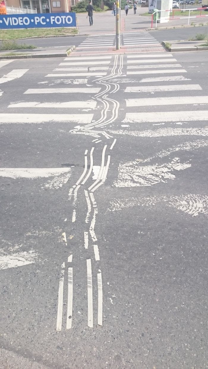 Guiding Tracks For Blind People On This Crosswalk Got Distorted Due To Cars Acceleration Forces Combined With Viscose Asphalt Over Time