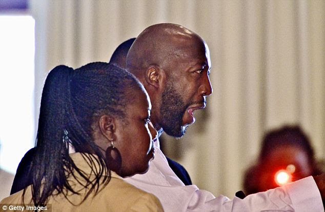 Outrage: Tracy Martin (center) was passionate at a meeting of the Sanford city commissioners Monday, alongside his ex-wife Sabrina Fulton