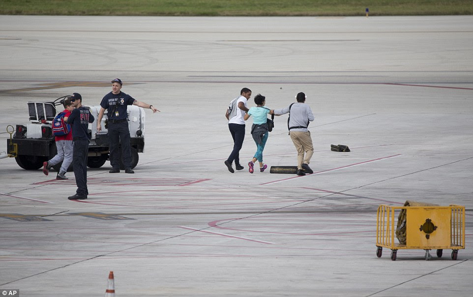 An official is seen directing people who were running on the tarmac in Florida on Friday afternoon