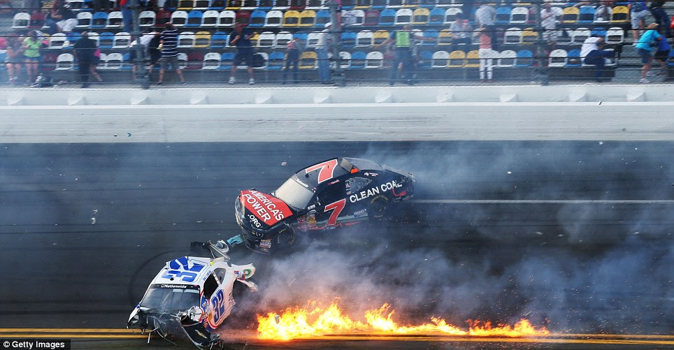 Fireball: Kyle Larson and Regan Smith clash on the final lap of the NASCAR Nationwide Series at Daytona, Florida, sending fire and metal across the track and even through the fencing 