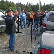 Electrician Kevin Slaney addresses workers gathered near the road to Long Harbour on Monday morning. 