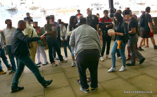 Dodgy cup game on London Southbank. © Nick Bailey