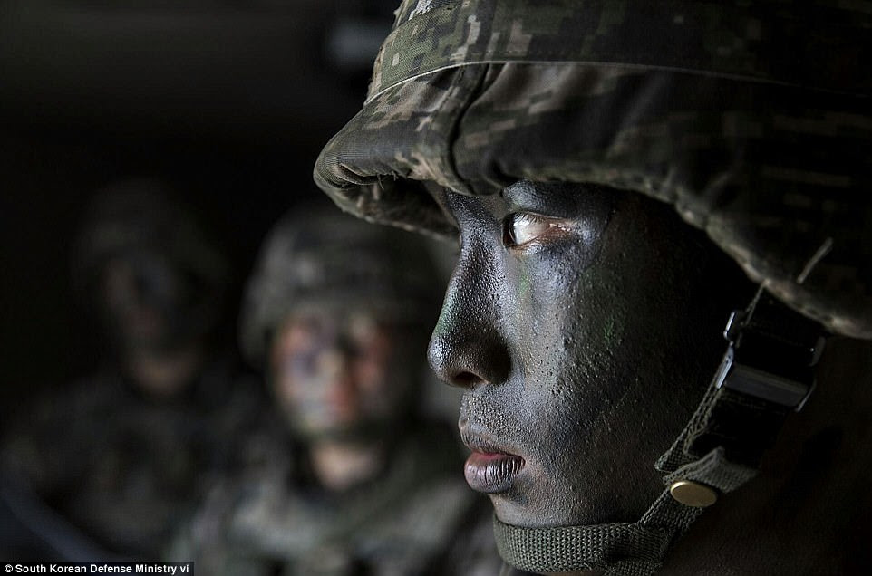 A day after the drills, South Korea and the United States completed the deployment of a US missile defense system to counter North Korean threats. Pictured above, a marine participates in exercises on Wednesday