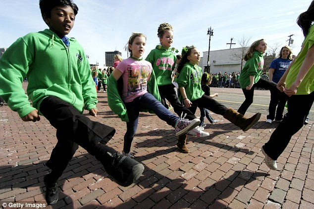 Pointed toes: Children in Detroit show off their Irish dancing skills in the annual parade
