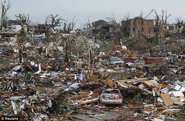 Obliterated: A neighbourhood in Joplin is devastated after the tornado, destroying buildings and littering vehicles throughout the city