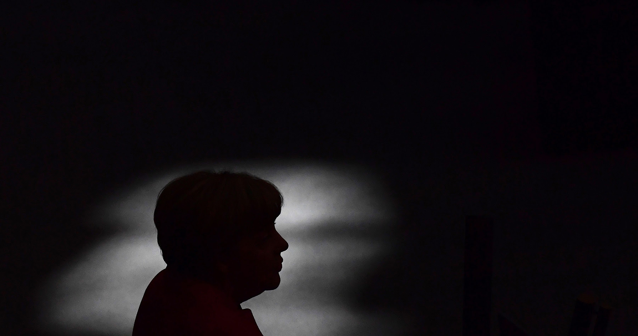 German Chancellor Angela Merkel is silhouetted as she gives a speech during a session of the German Bundestag (lower house of parliament) in Berlin on September 7, 2016. / AFP PHOTO / TOBIAS SCHWARZTOBIAS SCHWARZ/AFP/Getty Images