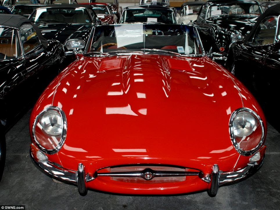 Rare: Dr Hull has travelled extensively around the world tracking down some of the rarest, original British models. Above, one of his classic motors, a red Jaguar E Type