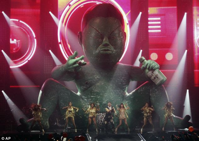 Family connections: South Koren rapper Psy's father now he has his own reason to celebrate as it has been revealed his component manufacturing firm has seen its share price shoot up as a result of his son's success