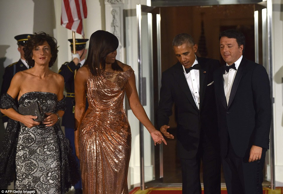 US President Barack Obama and First Lady Michelle Obama welcome Italian Prime Minister Matteo Renzi and his wife Agnese Landini on the North Portico of the White House before a state dinner in Washington