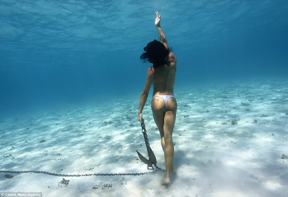 She practiced breathing in her bathtub after watching the Little Mermaid (pictured: Julia posing with an anchor in Tahiti)