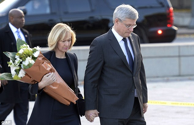 Saddened: Prime Minister Stephen Harper and his wife Laureen also paid their respects on Thursday by leaving flowers at the site where the soldier was gunned down