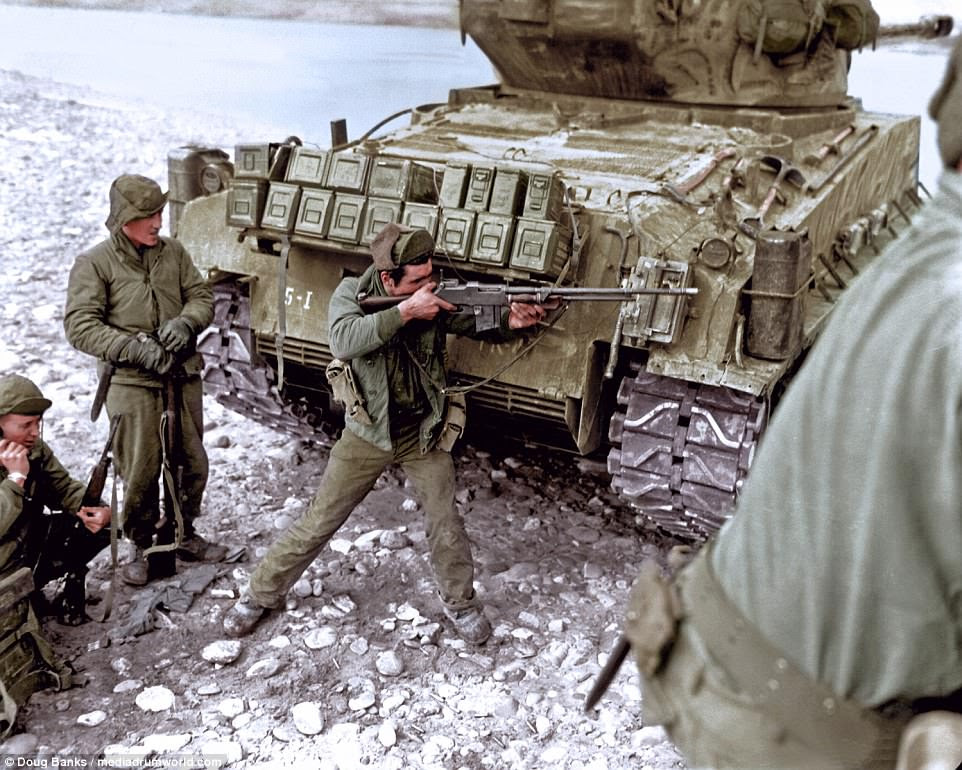The vivid color images show US soldiers setting fuses on anti-tank mines, bridging the four-foot gap over the seawall at 'Red Beach' in Inchon and taking cover behind a tank escort. The Marines were one of the only branches of the military that proved ready for deployment, having maintained their stocks of Second World War weapons and equipment