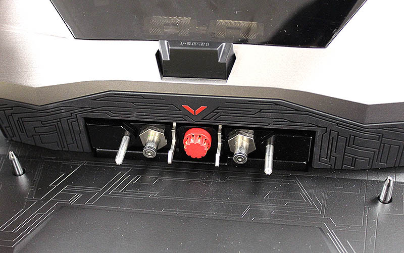 The red connector is for power while the two pipes flanking it are for liquid-cooling. Note also the alignment pins on the extreme left and right on the mounting plate. The push button above undocks the notebook and cuts off the liquid-cooling circuit.