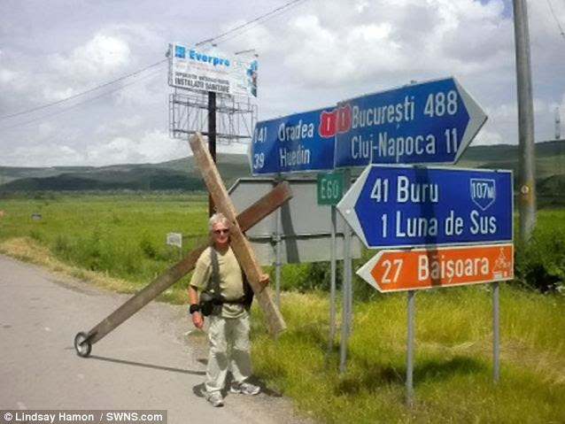 Trek: Mr Hamon carrying his cross through Romania. He has so far trekked through 19 countries around the world including India, New Zealand, Romania and Sri Lanka