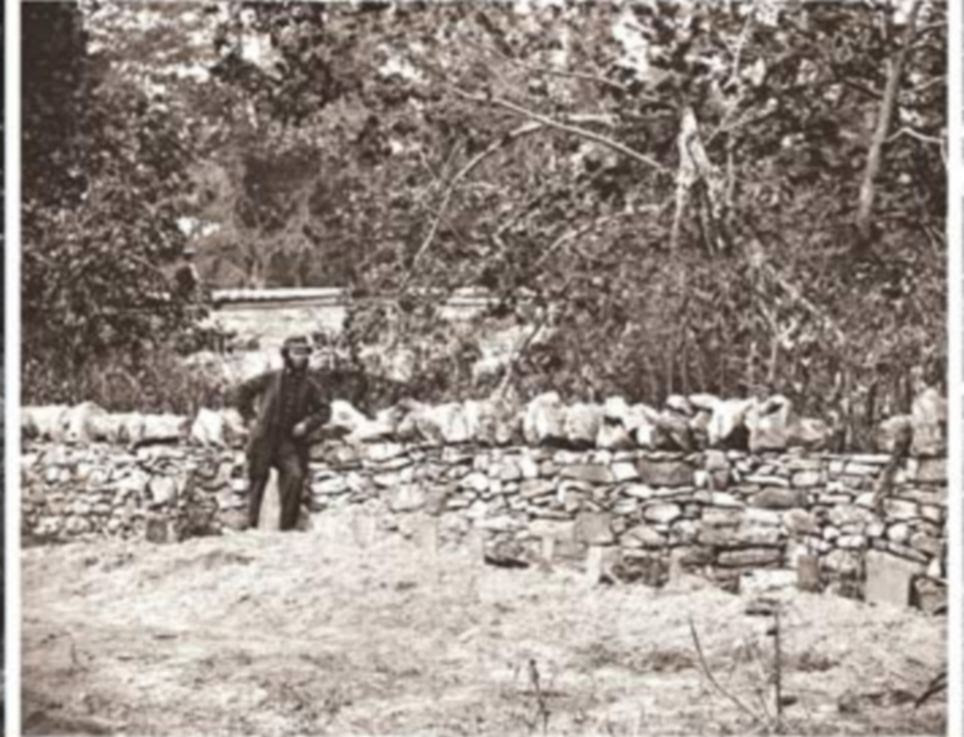Then: A soldier stands by graves of Federal soldiers near Burnside Bridge