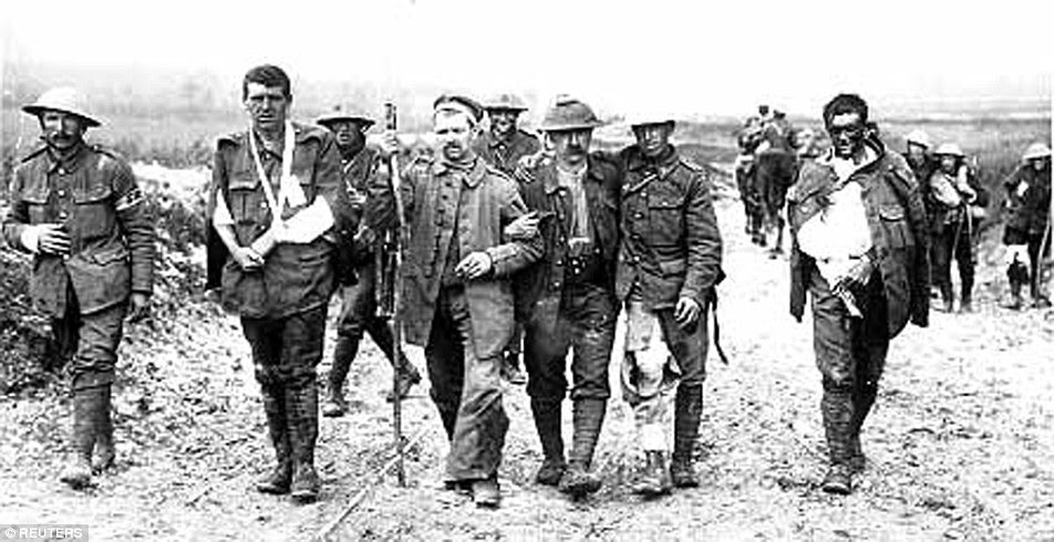 British soldiers wounded in the trenches on the Western Front during the First World War make their way back from the front line