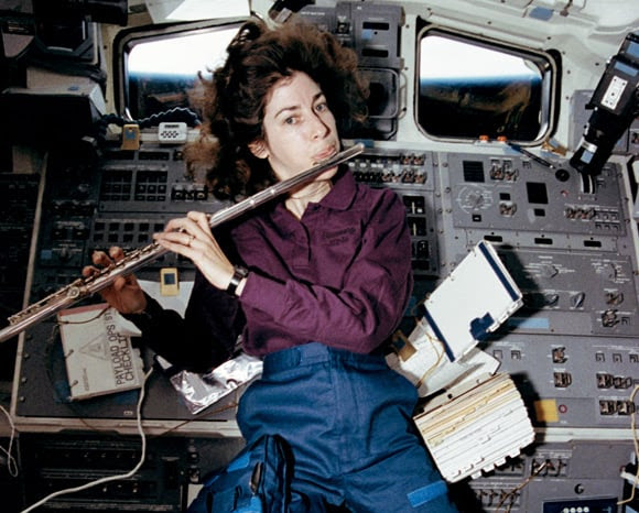 Ellen Ochoa plays the flute in space shuttle Discovery's aft flight deck in April 1993. Pic: NASA