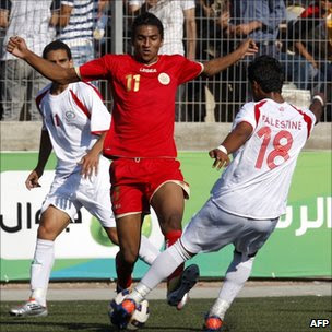 Palestinian and Bahraini players during their 2012 Olympic qualifying football match in the West Bank town of Al-Ram, near Ramallah, on June 23, 2011