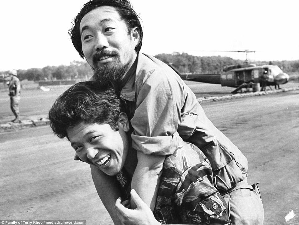 Terrence, or Terry, Khoo of ABC is pictured playfully jumping on the back of freelance Associated Press photographer Koichiro Morita. Khoo was killed in the summer of 1972 at the frontline of Quang Tri in South Vietnam
