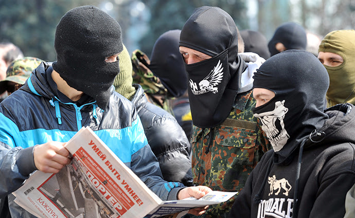Apoiadores do partido de direita Pravyi Sector (Setor de Direito) ler jornal como eles protestam em frente ao Parlamento ucraniano, em Kiev 28 de março de 2014. (AFP Photo / Genya Savilov)