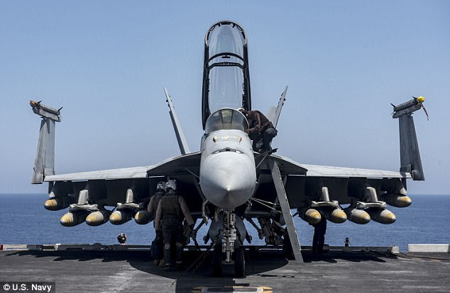 A US Navy aircraft is headed for Syria with a massive load of ten 1,000-pound bombs. Pictured is the F/A-18F Super Hornet, which is fully loaded with ten GBU-32 1,000 pound bombs aboard the aircraft carrier