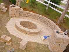 DIY fire pit. around $200 for pit and wall and pillars at $1.31/paver @ Home Improvement Ideas