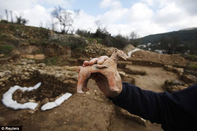 Archaeologist Anna Eirikh shows a horse figurine at the site on the outskirts of Jerusalem: Experts say the finds provide rare testimony of a ritual cult in the region at the start of the period of the royal House of David