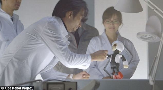 Kibo in the laboratory with its creators. Astronauts aboard the ISS are already taking part in trials with Kibo, which is designed to keep them company in space