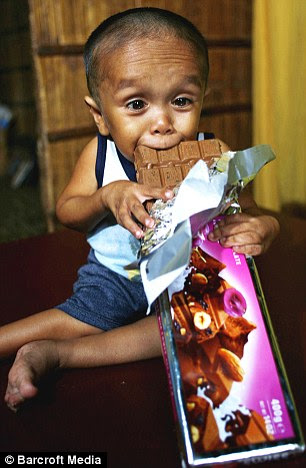 Happy: Although he cannot attend school and cannot walk far, Junrey says he is 'proud' to be the world's smallest man