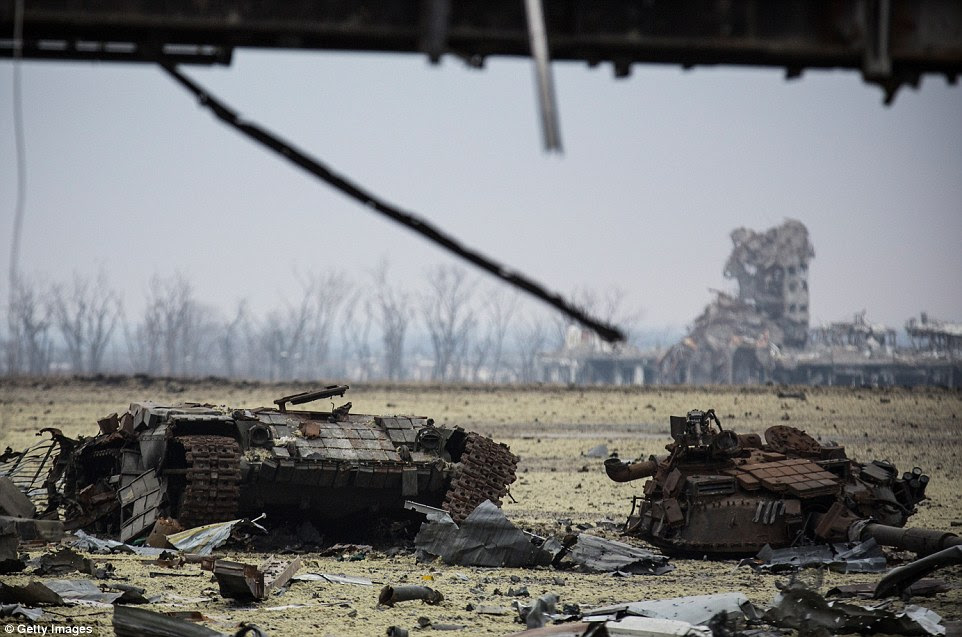 The twisted remains of a tank lie near Donetsk airport. On the left is its base, while metres to the right sits the turret