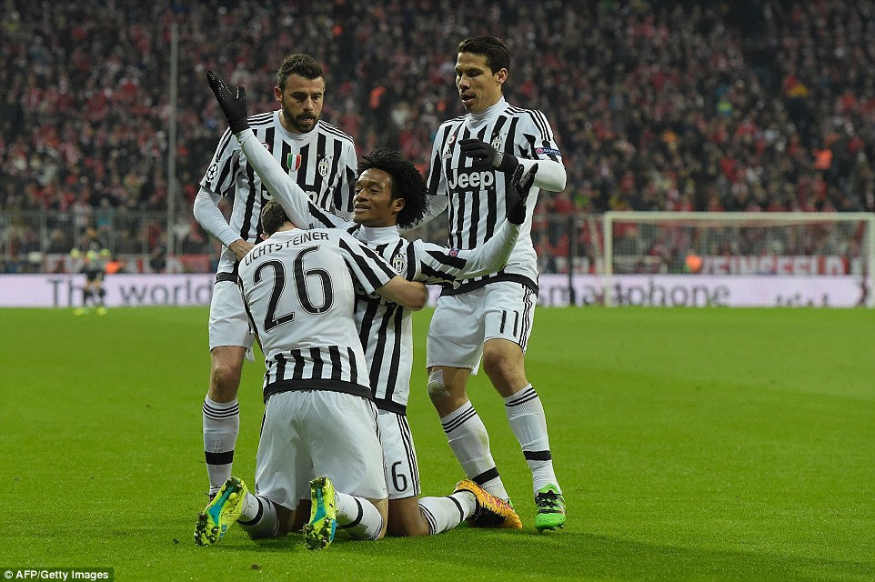 Cuadrado is congratulated by Juventus team-mates Stephan Lichtsteiner (second left), Andrea Barzagli (left) and midfielder Hernanes